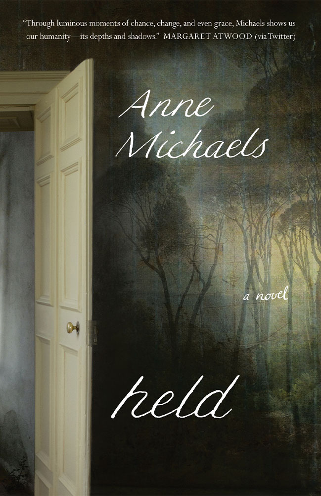 held by Anne Michaels book cover